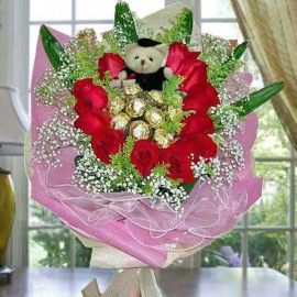 11 Red Roses with 9 Ferrero Roche and  Graduation Bear Hand Bouq