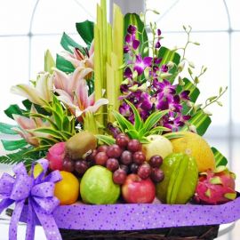 Pink Lily & Orchid With Mixed Fruits Basket Arrangement